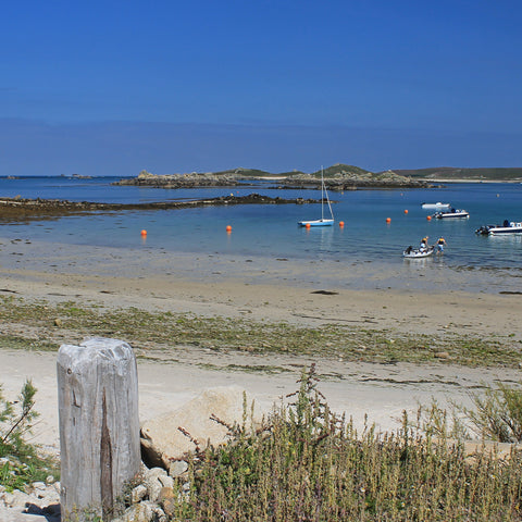Photo from Friendly Guides Isles of Scilly Guidebook looking over Old Grimsby Harbour to Northwethel, Tean and St Martin's on the Isles of Scilly