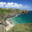 Photo from Friendly Guides Lizard Guidebook showing Housel Bay beach and Pen Olver on the Lizard Peninsula in West Cornwall