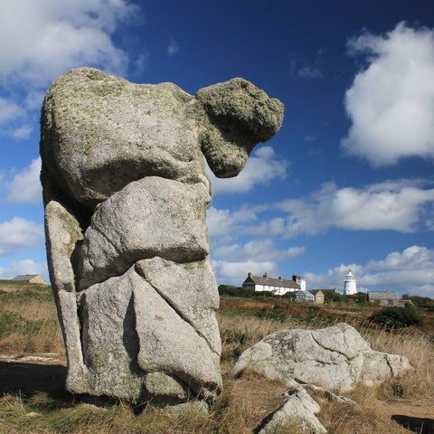 Photo from Friendly Guides Isles of Scilly Guidebook showing the Nag's Head Rock on St Agnes, Isles of Scilly. In the background Coastguards Cafe and St Agnes Lighthouse.