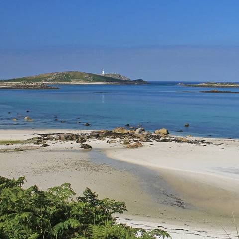 Photo from Friendly Guides Isles of Scilly Guidebook showing looking over Blockhouse Beach on Tresco, Isles of Scilly to St Helen's and Round Island Lighthouse.