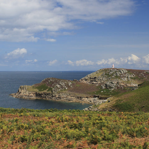 Photo from Friendly Guides Isles of Scilly Guidebook looking over Burnt Hill to Chapel Down Daymark at St Martin's Head on the Isles of Scilly. Land's End is in the far distance.