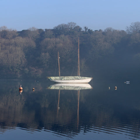 Photo from the Falmouth and the Roseland Guidebook showing a yacht moored in Cowlands Creek near Trelissick