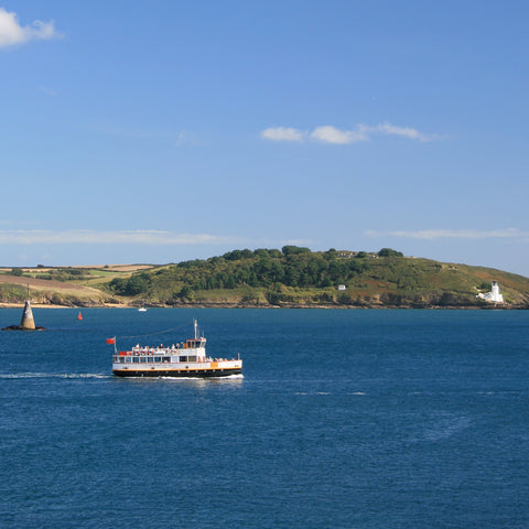 Photo from the Falmouth and the Roseland Guidebook showing a ferry on Carrick Roads passing Black Rock and St Anthony Lighthouse on the Roseland, Cornwall